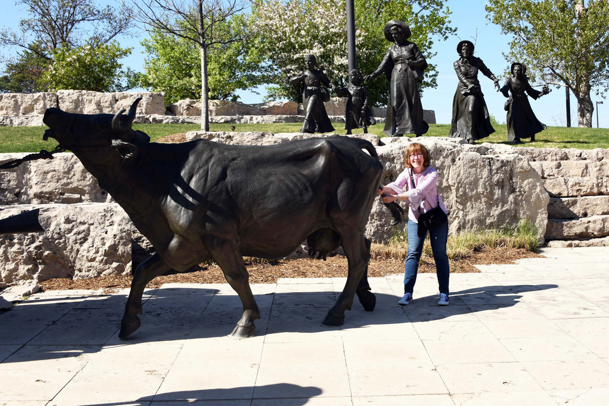 018 Denise Benegas having fun with the bronze sculptures.JPG